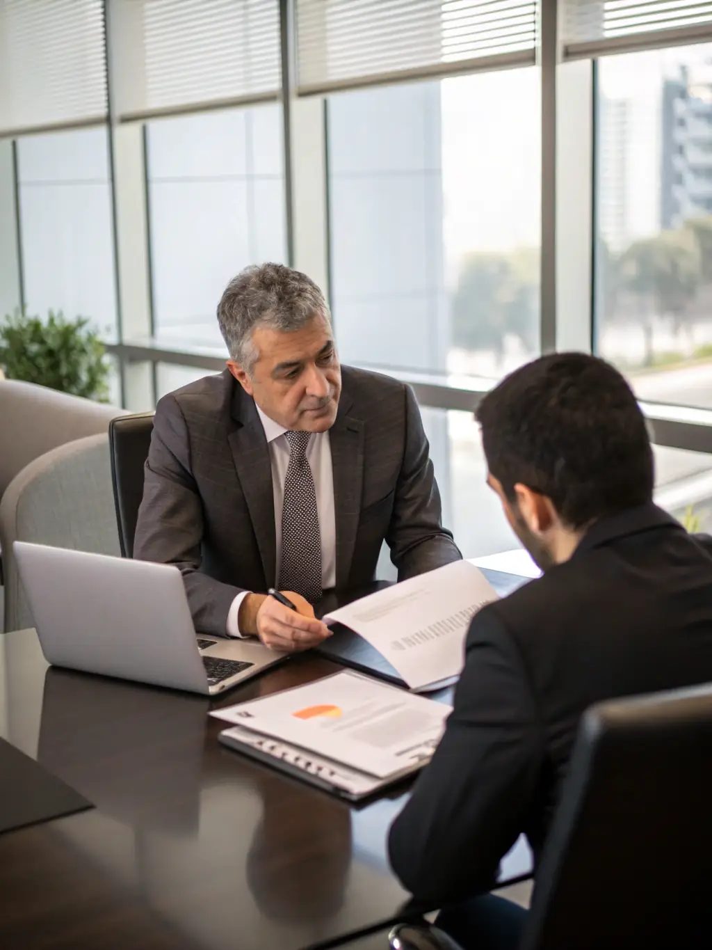 A tax consultant reviewing tax documents, highlighting key figures and discussing strategies with a client in a well-lit office. The image should convey expertise and trust.